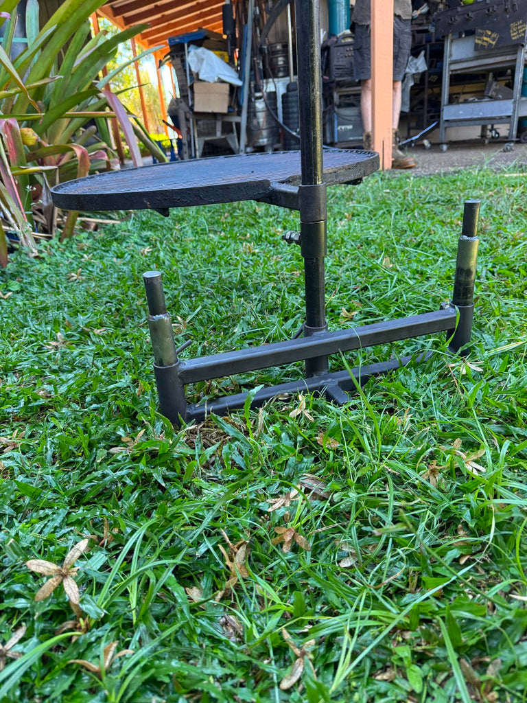 Black metal stand on grass with outdoor background