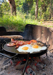 Fried eggs and bacon on a BBQ