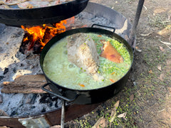 Stew being cooked in Disco over an open fire outdoors