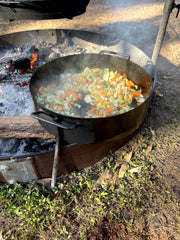 Aussie Disco frying off vegetables over a campfire