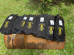 Fire Gloves on barrel on a green grassy lawn.