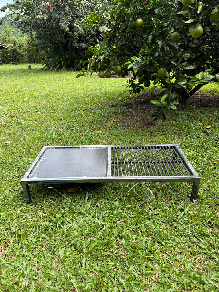 Metal grill on grass with trees in the background