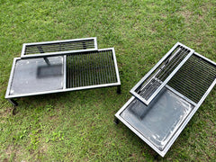 Metal grill grates on a grassy surface