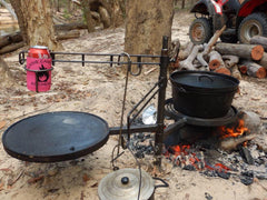 Swinging hot plate and grill setup at campsite