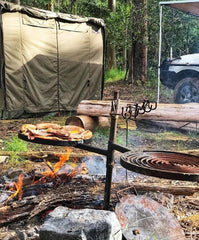Campfire cooking with swinging hot plate and grill in outdoor setting