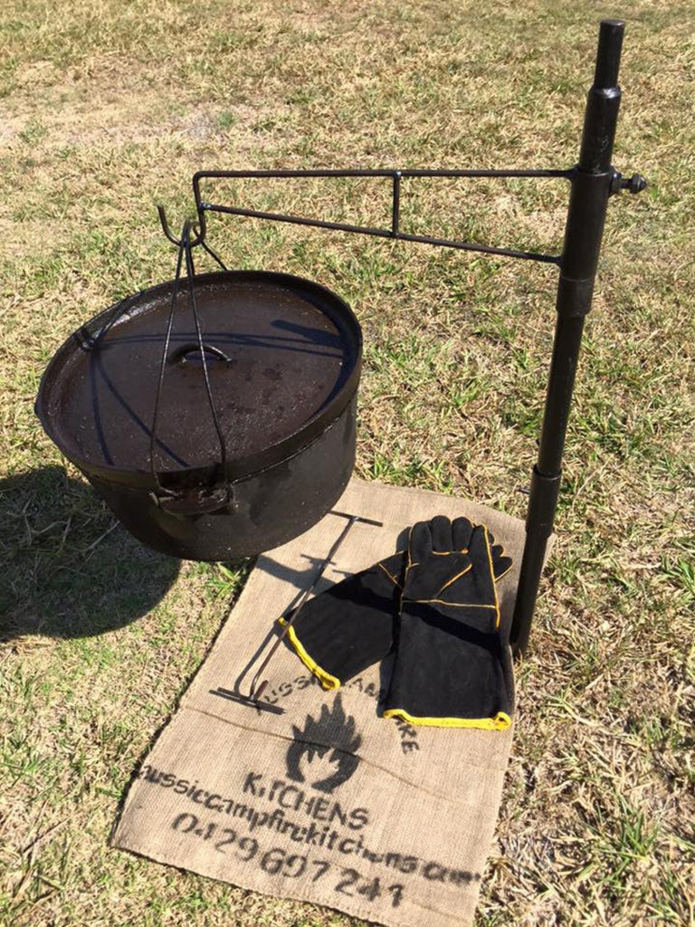 Camp oven kit accessories laid out - includes hook, lid lifter, collars and heat-resistant gloves