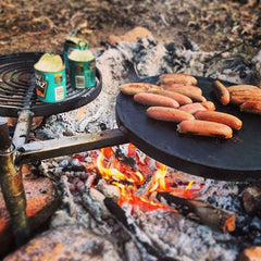 Swinging hot plate and grill cooking setup at campsite