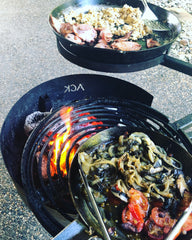 www.aussiecampfirekitchens.com SKILLET & BBQ Pan Breakfast using the ACK Camping Fire Pit with Swinging Grill & Cradle